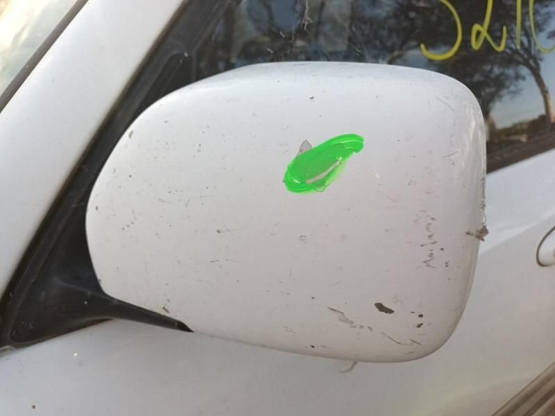 A White Car With a Green Sticker on the Side Mirror — South West 4WD Wreckers In Harristown, QLD