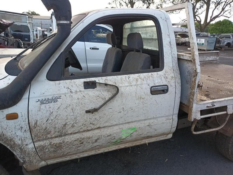 A White Truck With a Dirty Side is Parked in a Parking Lot — South West 4WD Wreckers In Brisbane, QLD