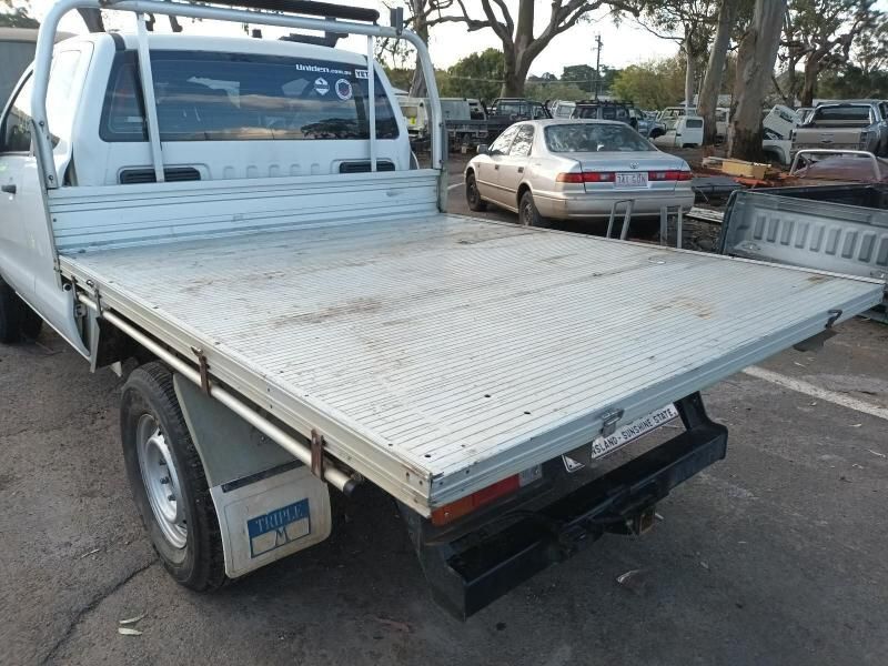 A White Truck With a Flat Bed is Parked in a Parking Lot — South West 4WD Wreckers In Brisbane, QLD