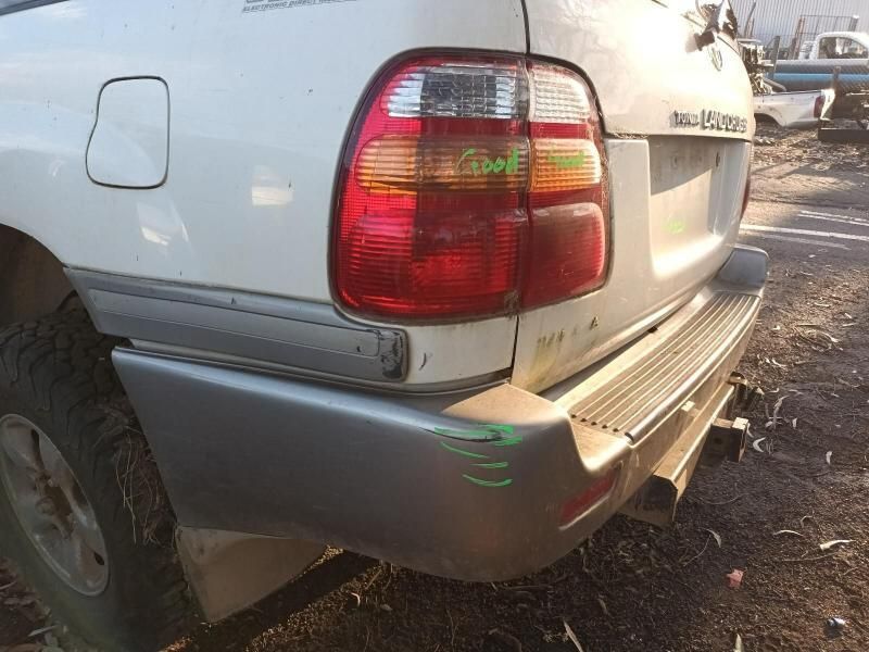 A White Car With a Red Tail Light is Parked in a Lot — South West 4WD Wreckers In Harristown, QLD