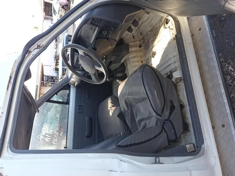 The Inside of a White Car With the Door Open and a Steering Wheel — South West 4WD Wreckers In Brisbane, QLD
