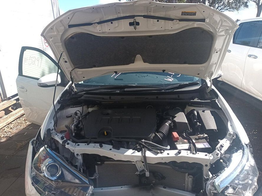 The Hood of a White Car is Open and the Engine is Visible — South West 4WD Wreckers in Harristown, QLD