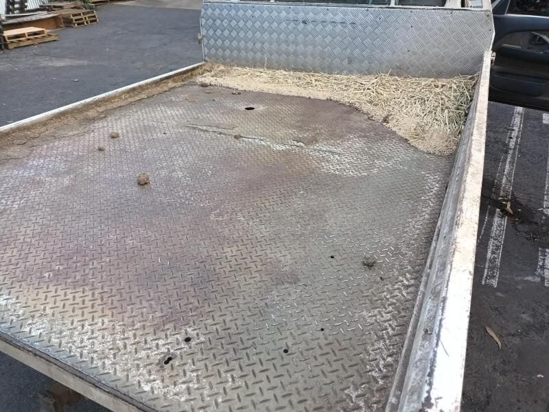 A Metal Tray is Sitting in a Parking Lot Next to a Car — South West 4WD Wreckers In Brisbane, QLD
