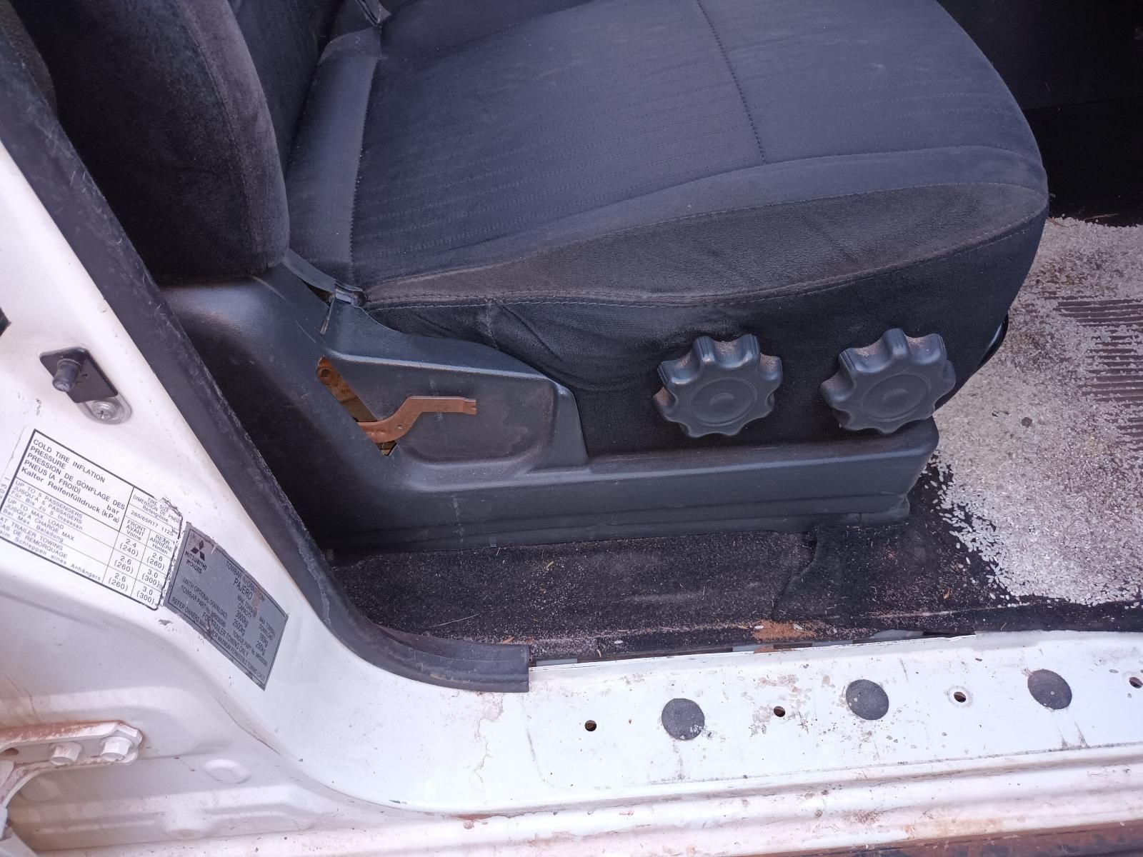A Car Seat is Sitting in the Doorway of a White Car — South West 4WD Wreckers In Brisbane, QLD