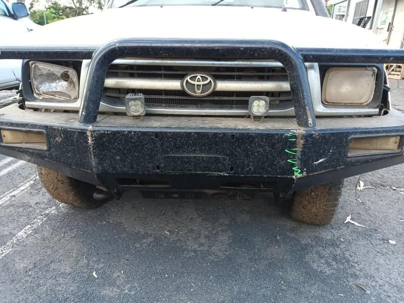 A White Toyota With a Black Bumper is Parked in a Parking Lot — South West 4WD Wreckers In Brisbane, QLD