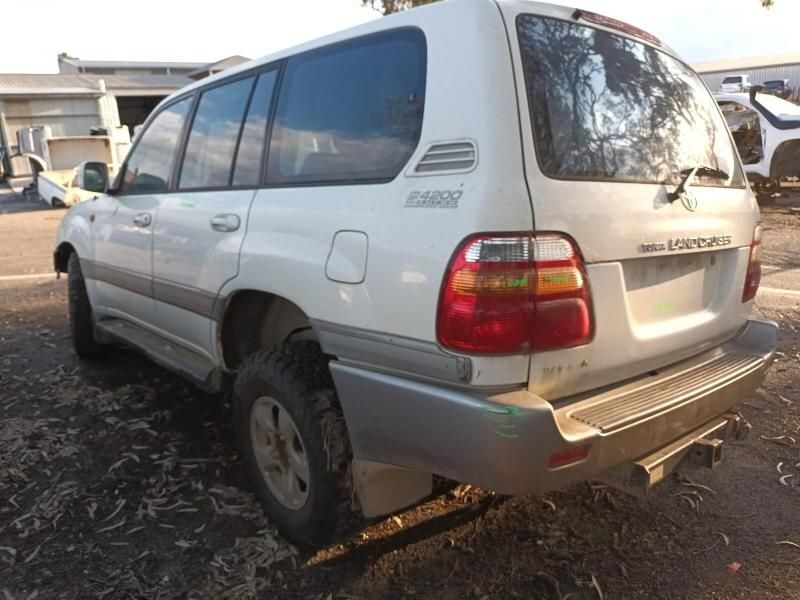 A White Toyota Land Cruiser is Parked in a Parking Lot — South West 4WD Wreckers In Harristown, QLD