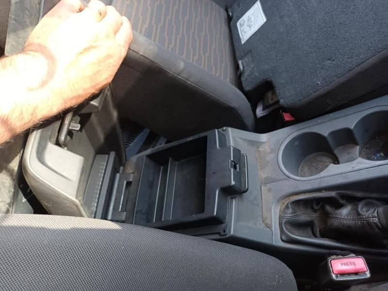 A Person is Sitting in a Car With Their Hand on the Arm Rest — South West 4WD Wreckers In Brisbane, QLD