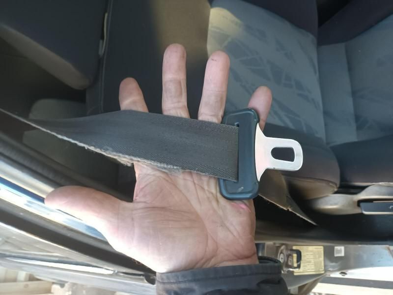 A Person is Holding a Seat Belt in Their Hand — South West 4WD Wreckers In Brisbane, QLD