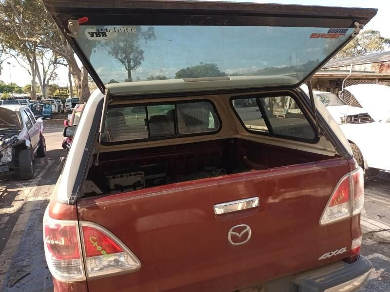 A Red Mazda Truck is Parked in a Parking Lot — South West 4WD Wreckers In Harristown, QLD
