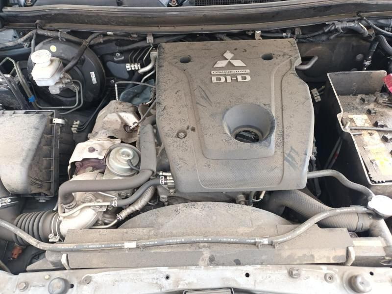 The Engine of a Dirty Mitsubishi Truck is Shown Under the Hood — South West 4WD Wreckers In Brisbane, QLD