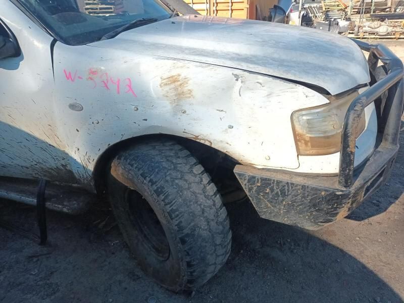 A White Truck With a Broken Hood is Parked on the Side of the Road — South West 4WD Wreckers In Harristown, QLD