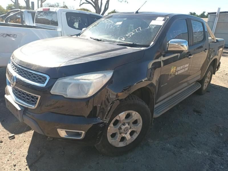 A Black Truck is Parked in a Lot Next to a White Truck — South West 4WD Wreckers In Harristown, QLD