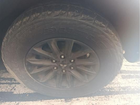 A Close Up of a Tire on a Car in a Parking Lot — South West 4WD Wreckers In Brisbane, QLD
