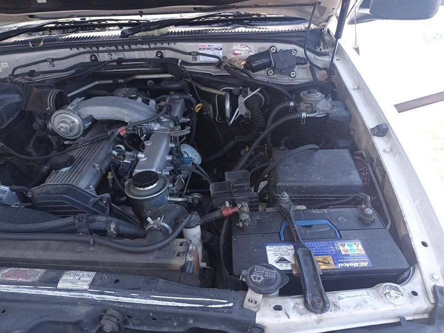 The Engine of a White Car is Shown with the Hood Open — South West 4WD Wreckers in Harristown, QLD 