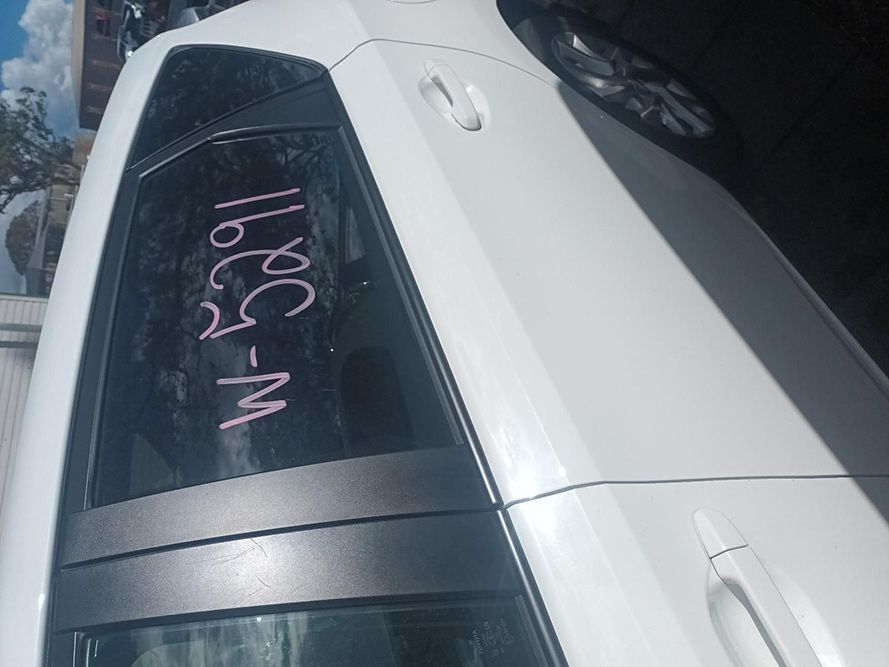 A White Car with a Written on the Back Window — South West 4WD Wreckers in Harristown, QLD