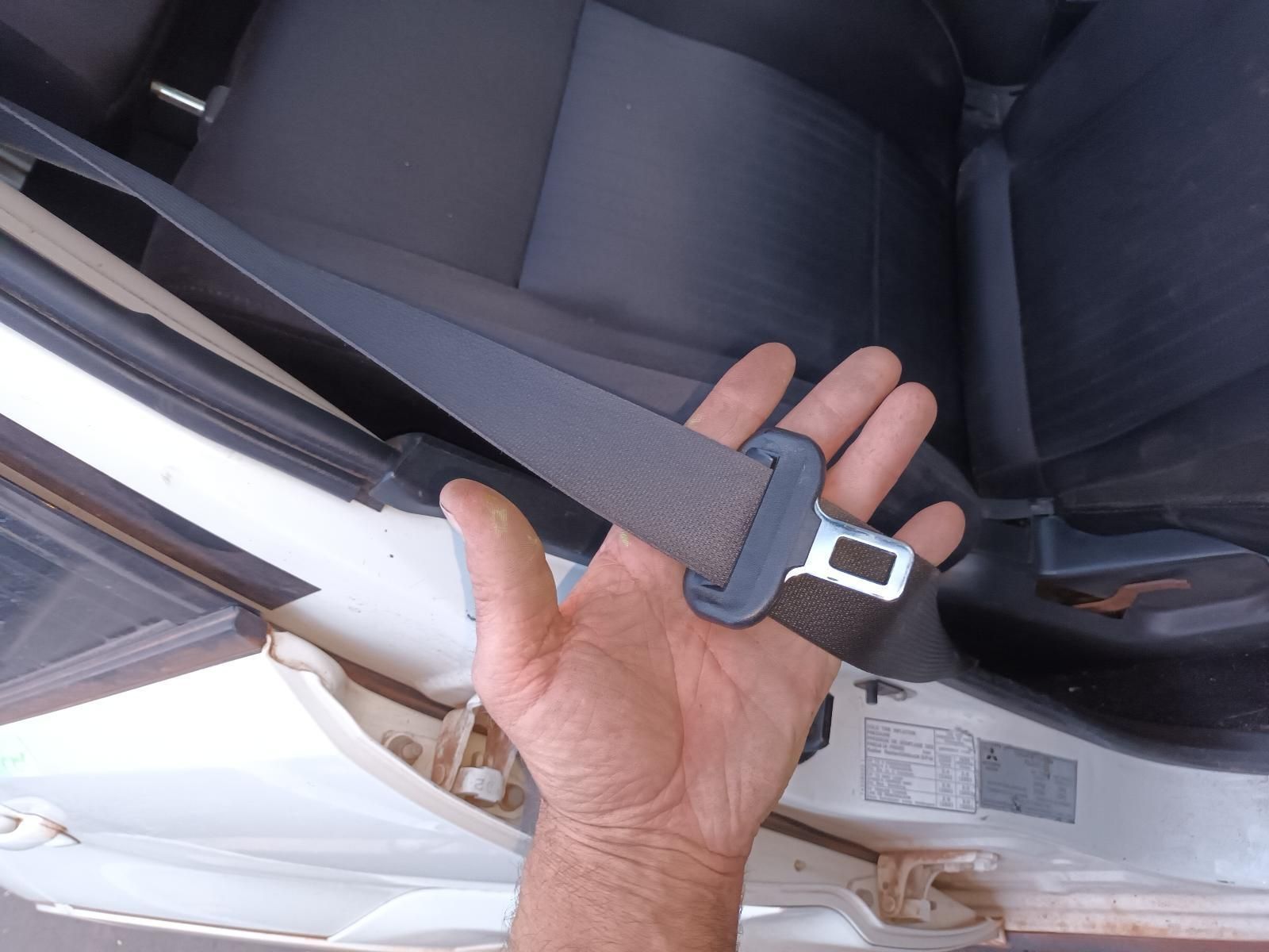 A Person is Holding a Seat Belt in Their Hand — South West 4WD Wreckers In Brisbane, QLD