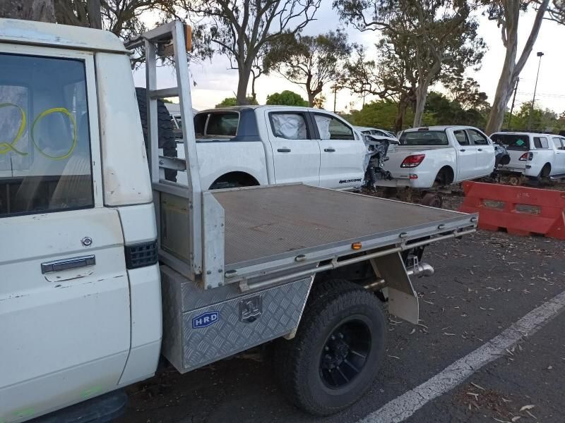 A White Truck With a Flat Bed is Parked in a Parking Lot — South West 4WD Wreckers In Brisbane, QLD