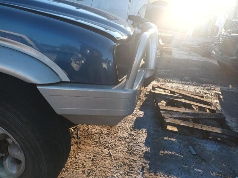 A Blue Truck is Parked Next to a Wooden Pallet — South West 4WD Wreckers In Brisbane, QLD