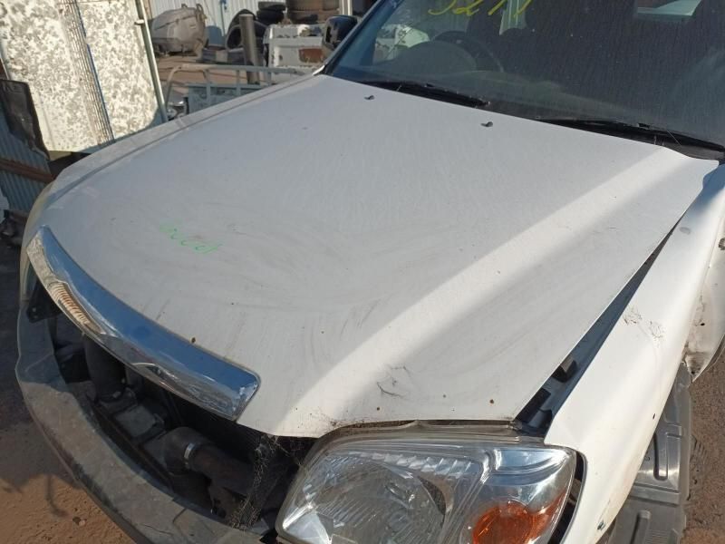A White Truck With a Broken Hood is Parked on the Side of the Road — South West 4WD Wreckers In Harristown, QLD