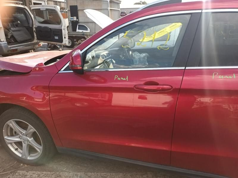 A Red Car is Sitting in a Parking Lot With the Door Open — South West 4WD Wreckers In Brisbane, QLD