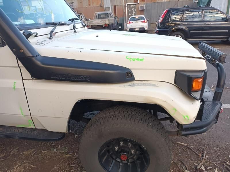 A White Jeep With a Snorkel on the Hood is Parked in a Parking Lot — South West 4WD Wreckers In Brisbane, QLD