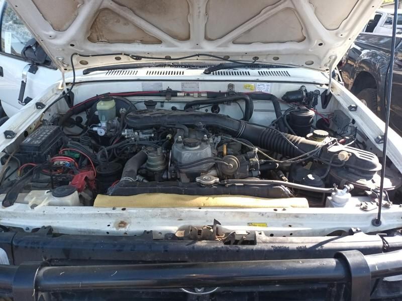 The Engine of a White Truck is Shown With the Hood Open— South West 4WD Wreckers In Brisbane, QLD