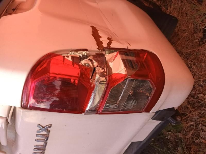 A White Hilux With a Damaged Tail Light — South West 4WD Wreckers In Harristown, QLD
