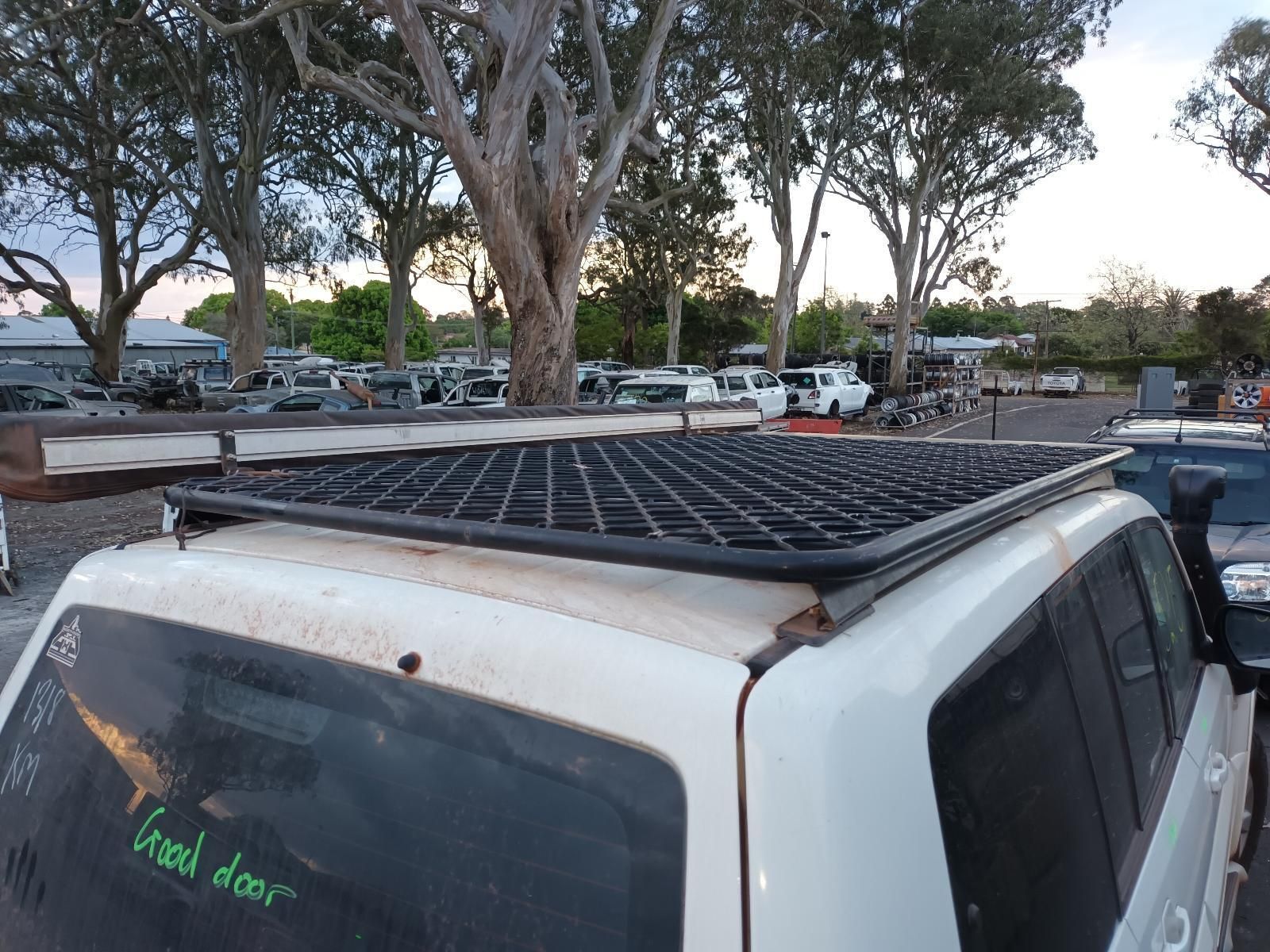 A White Suv With a Roof Rack is Parked in a Parking Lot — South West 4WD Wreckers In Brisbane, QLD