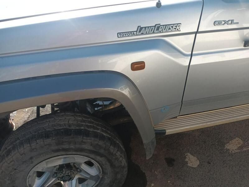 A Silver Land Cruiser is Parked on the Side of the Road — South West 4WD Wreckers In Harristown, QLD