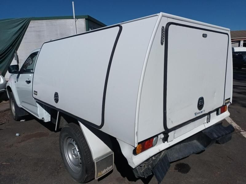 A White Truck With a Canopy on the Back is Parked in a Parking Lot — South West 4WD Wreckers In Harristown, QLD