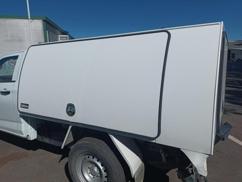 A White Truck With a Canopy is Parked on the Side of the Road — South West 4WD Wreckers In Harristown, QLD
