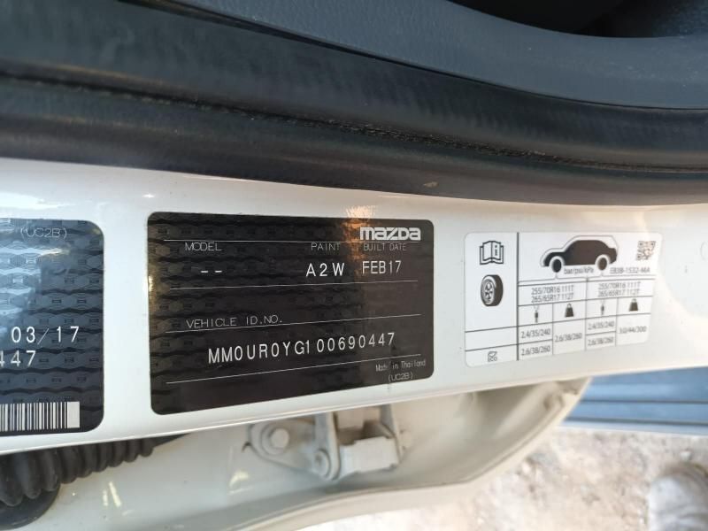 A White Mazda Car With a Sticker on the Side of It — South West 4WD Wreckers In Harristown, QLD