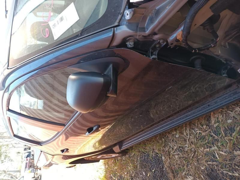 A Black Car is Parked in the Grass With the Door Open — South West 4WD Wreckers In Harristown, QLD