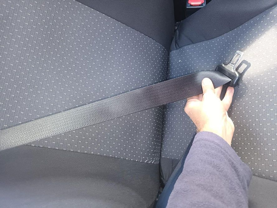 A Person is Putting on a Seat Belt in a Car — South West 4WD Wreckers in Harristown, QLD