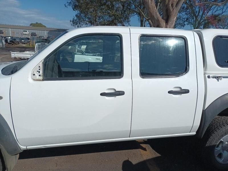 A White Truck is Parked in a Parking Lot Next to a Tree — South West 4WD Wreckers In Harristown, QLD