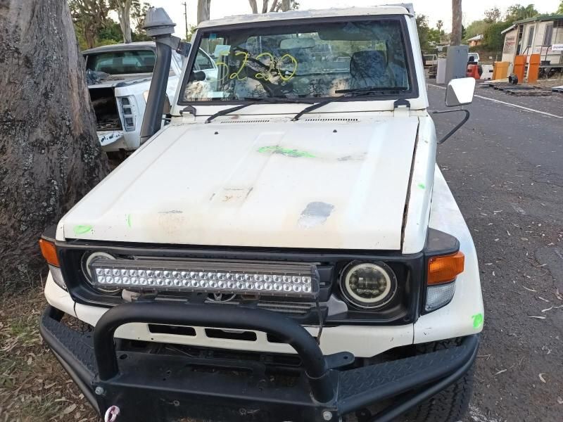 A White Truck With a Black Bumper is Parked on the Side of the Road — South West 4WD Wreckers In Brisbane, QLD