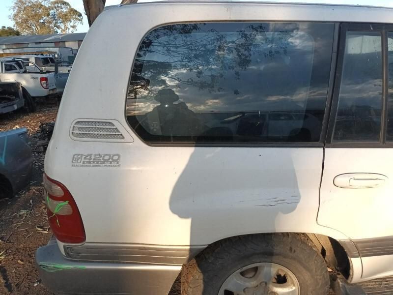 A White Toyota Land Cruiser is Parked in a Lot — South West 4WD Wreckers In Harristown, QLD