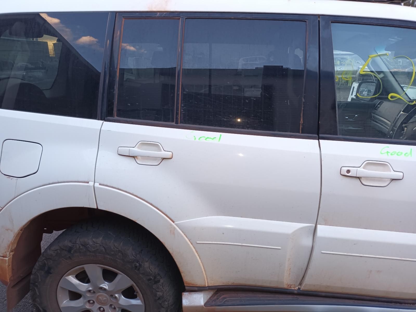 A White Suv is Parked on the Side of the Road — South West 4WD Wreckers In Brisbane, QLD
