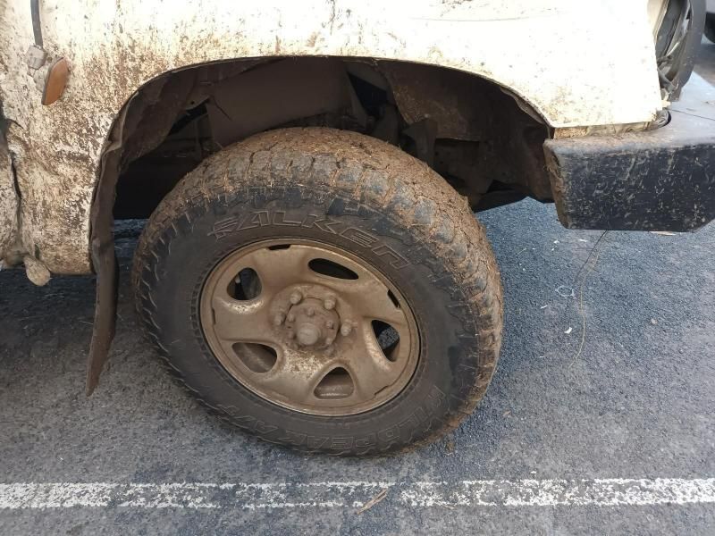 A Close Up of a Muddy Tire on a White Truck — South West 4WD Wreckers In Brisbane, QLD