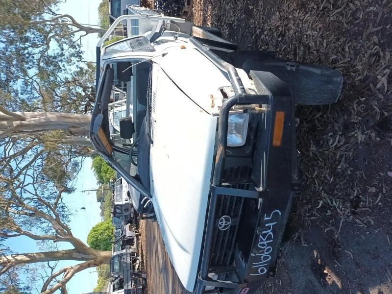 A White Toyota Truck With a License Plate That Says 6169b345 — South West 4WD Wreckers In Brisbane, QLD