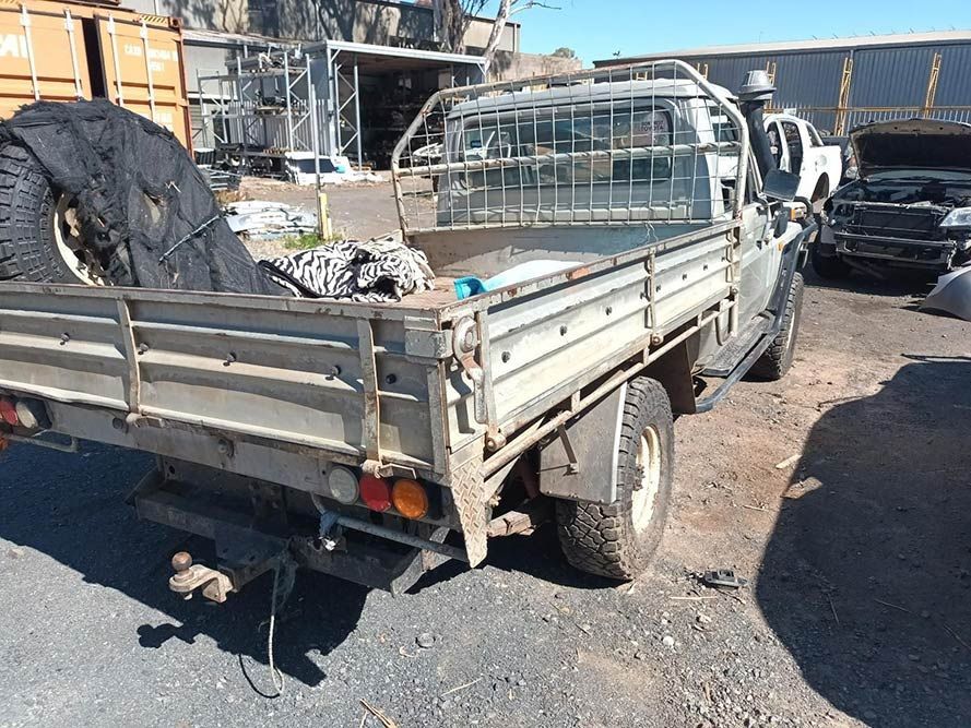 A Truck with a Flat Bed is Parked on the Side of the Road — South West 4WD Wreckers in Harristown, QLD