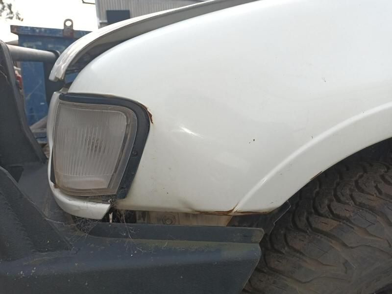 A Close Up of a White Car 's Front Fender — South West 4WD Wreckers In Harristown, QLD