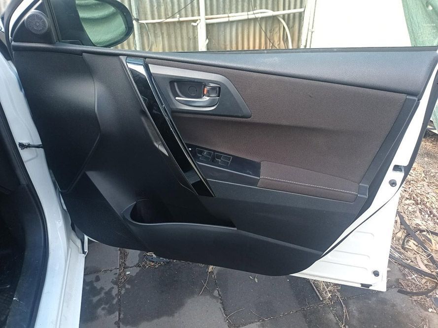 A White Car with the Door Open is Parked on the Side of the Road — South West 4WD Wreckers in Harristown, QLD