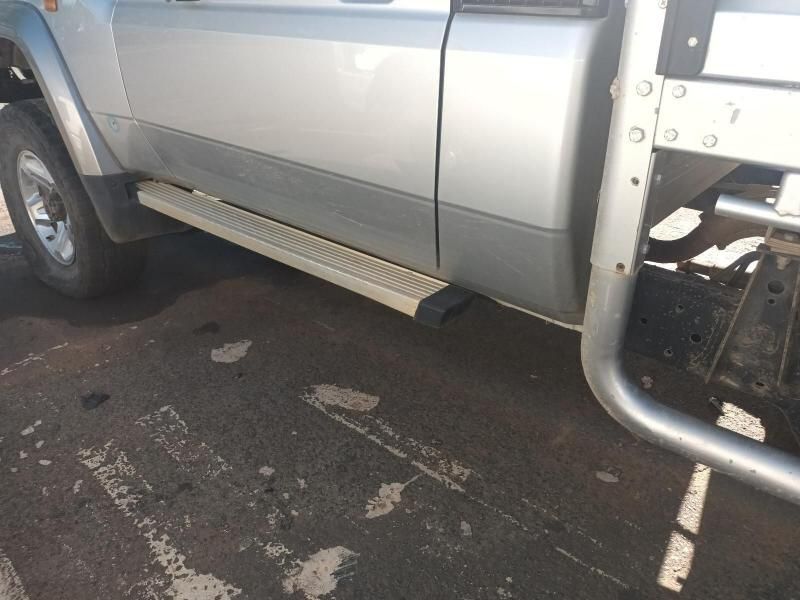 A Silver Truck is Parked on the Side of the Road — South West 4WD Wreckers In Harristown, QLD