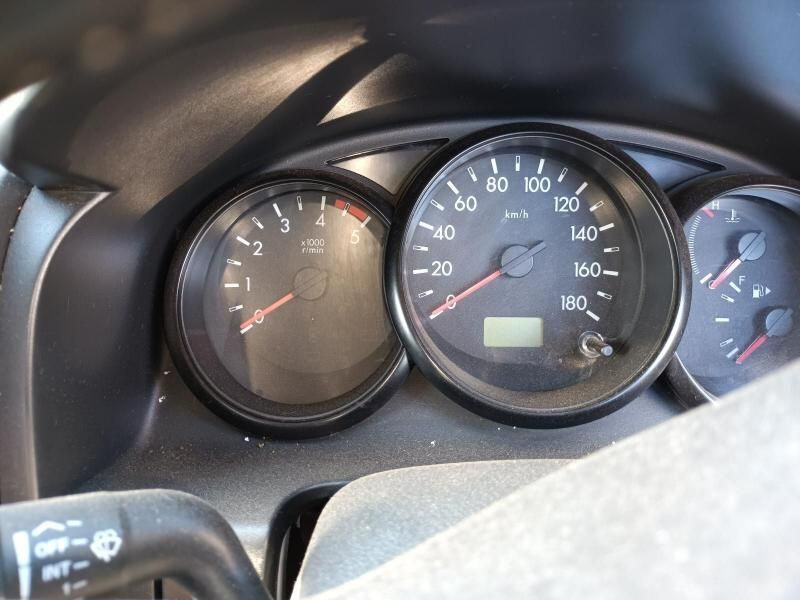 A Close Up of a Car Dashboard With a Speedometer and a Tachometer