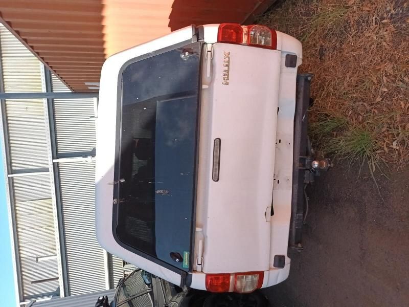 A White Hilux Truck is Parked on the Side of the Road — South West 4WD Wreckers In Harristown, QLD