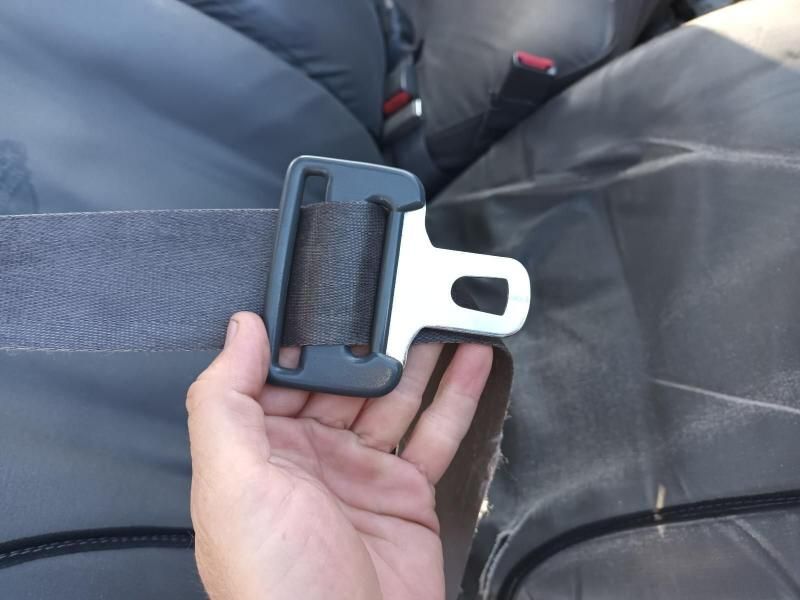 A Person is Holding a Seat Belt in Their Hand — South West 4WD Wreckers In Brisbane, QLD