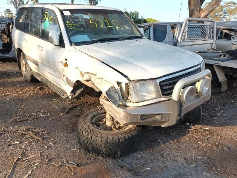 A White SUV With a Damaged Front End is Parked in a Lot — South West 4WD Wreckers In Harristown, QLD