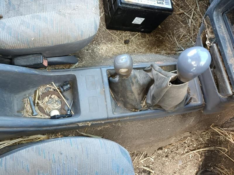 A Car 's Shifter is Sitting in the Dirt Next to a Battery — South West 4WD Wreckers In Brisbane, QLD