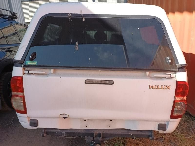 A White Hilux Truck With a Canopy on Top of It — South West 4WD Wreckers In Harristown, QLD